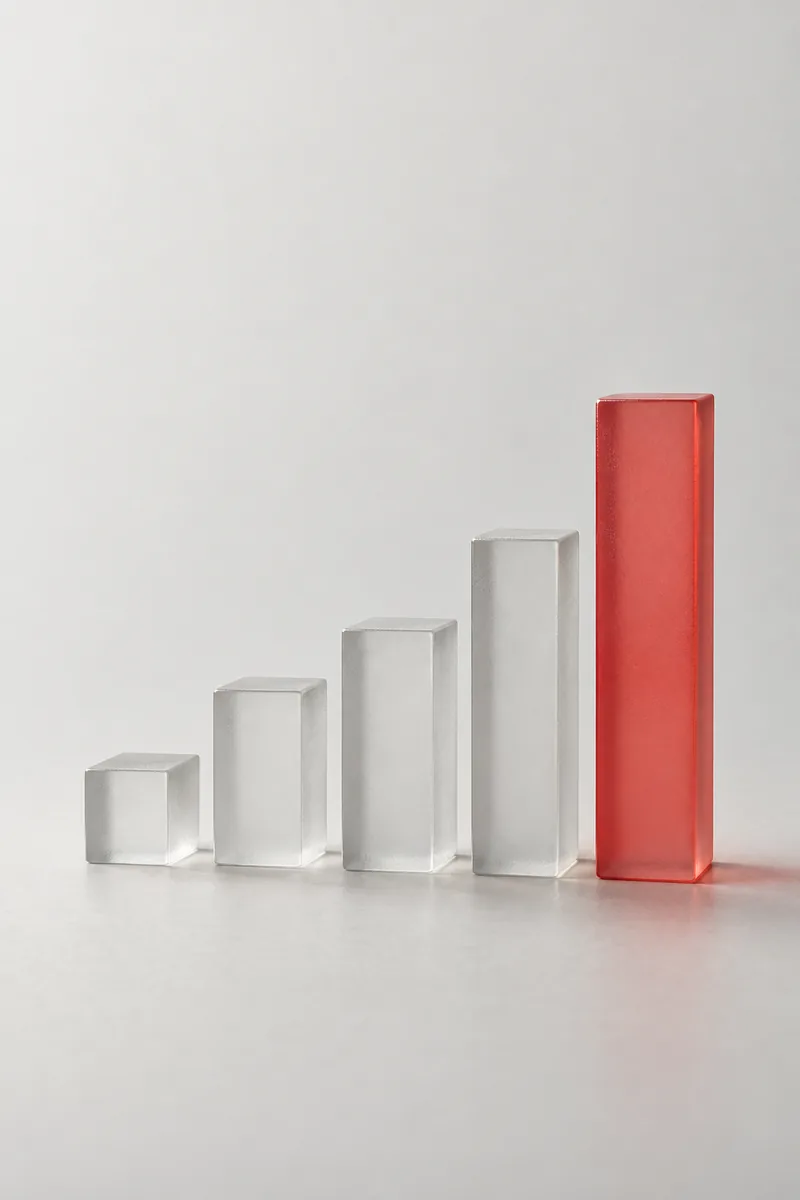 Frosted glass blocks arranged like a bar chart, the tallest one red